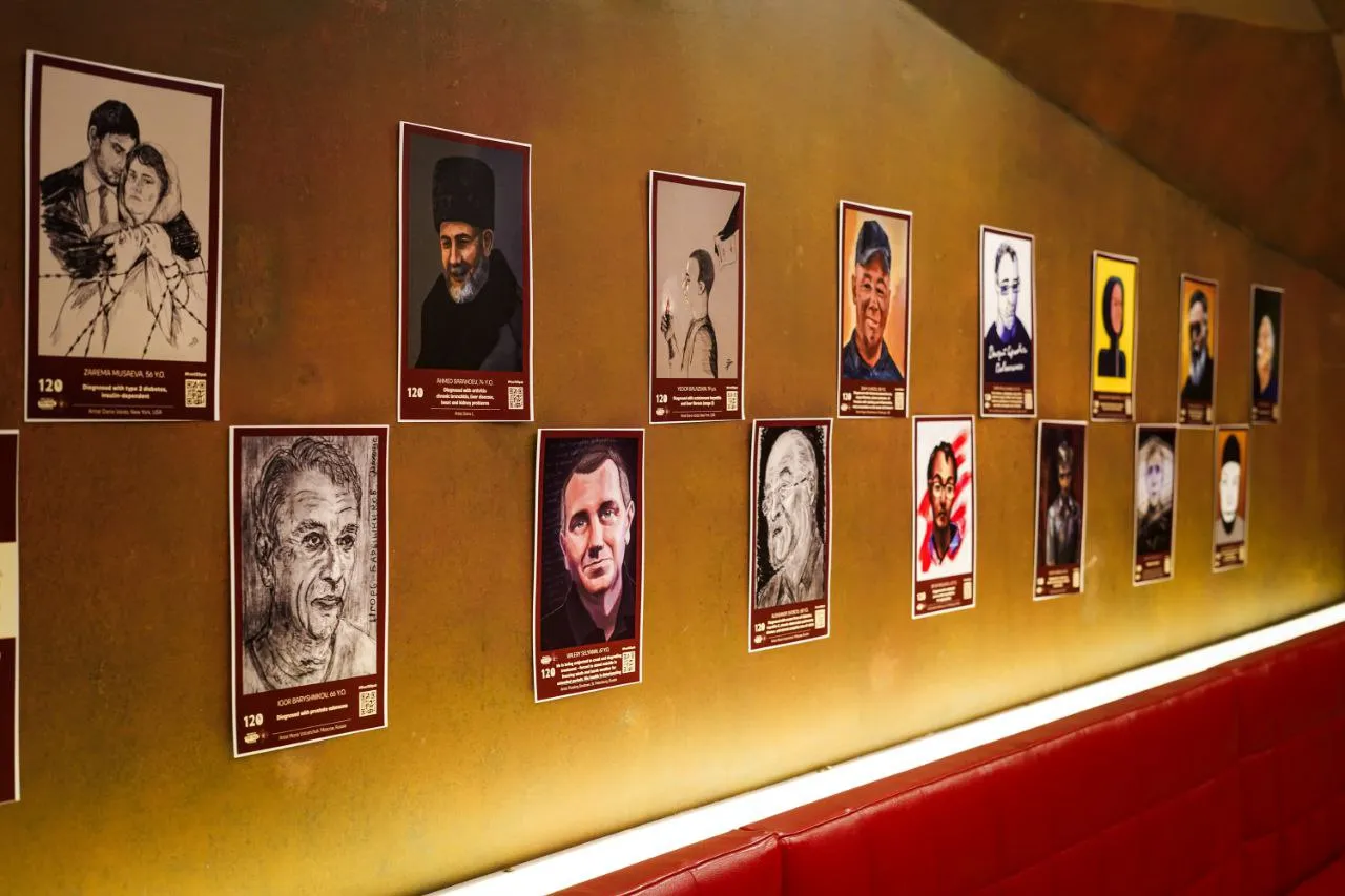 Portraits of Hope exhibition in Prague: framed portraits hung along a gallery wall